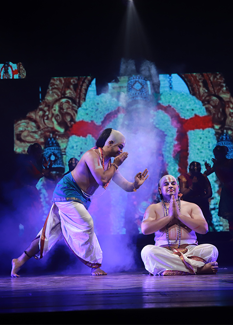 Stage still — Sri Ramanuja Vybhavam, ensemble in performance, warm wash