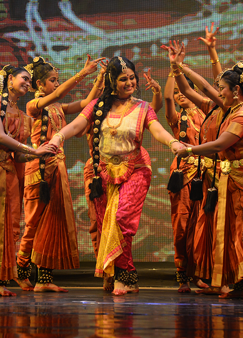 Stage still — Chilapadhikaram, ensemble in performance, warm wash