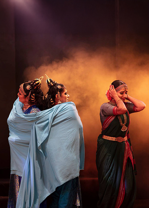 Stage still — Chitrangada, ensemble in performance, warm wash